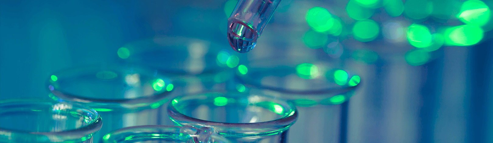 Close up of a pipette adding liquid to a tray of test tubes in a third party supplement testing laboratory