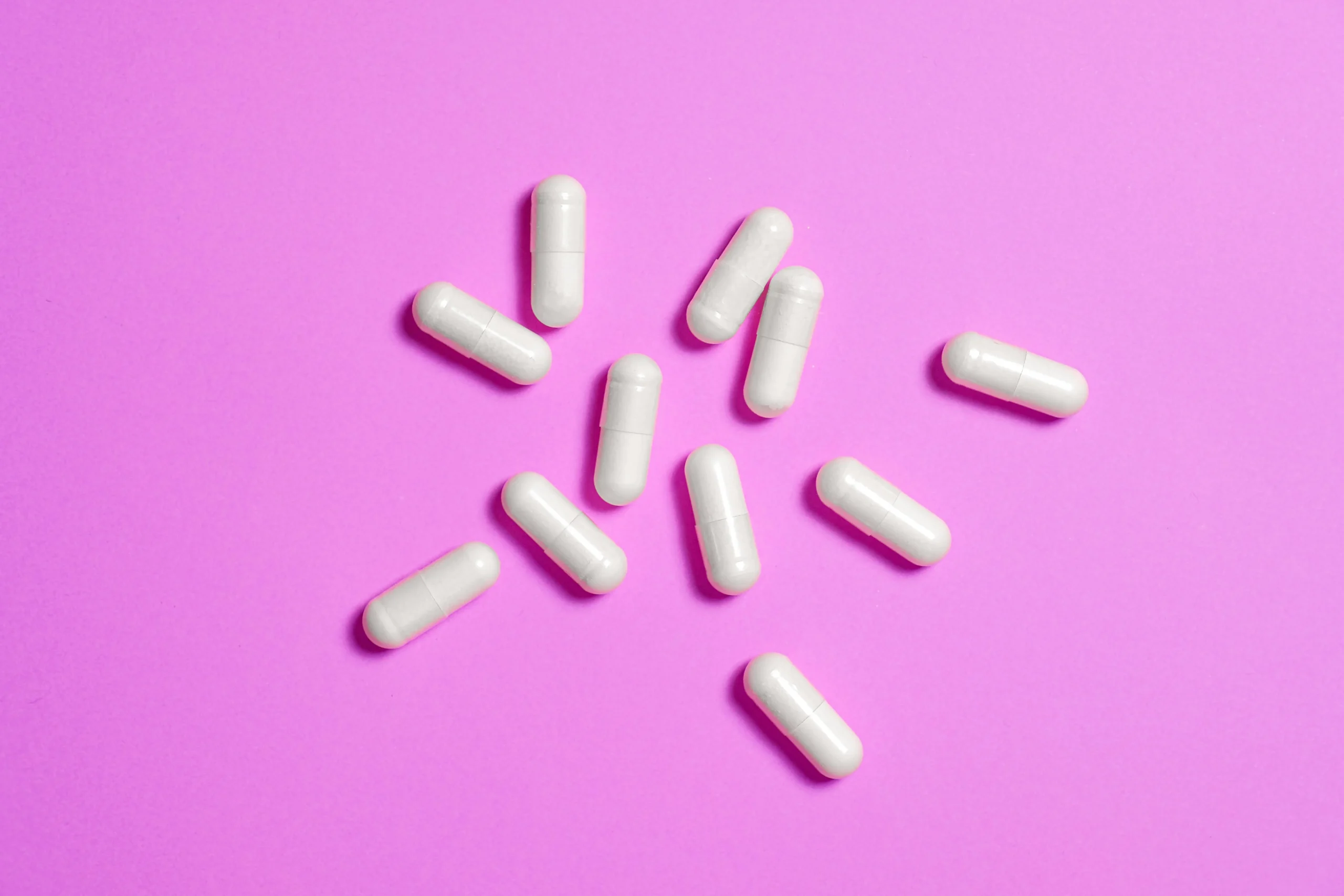 berberine capsules for weight loss against a pink background