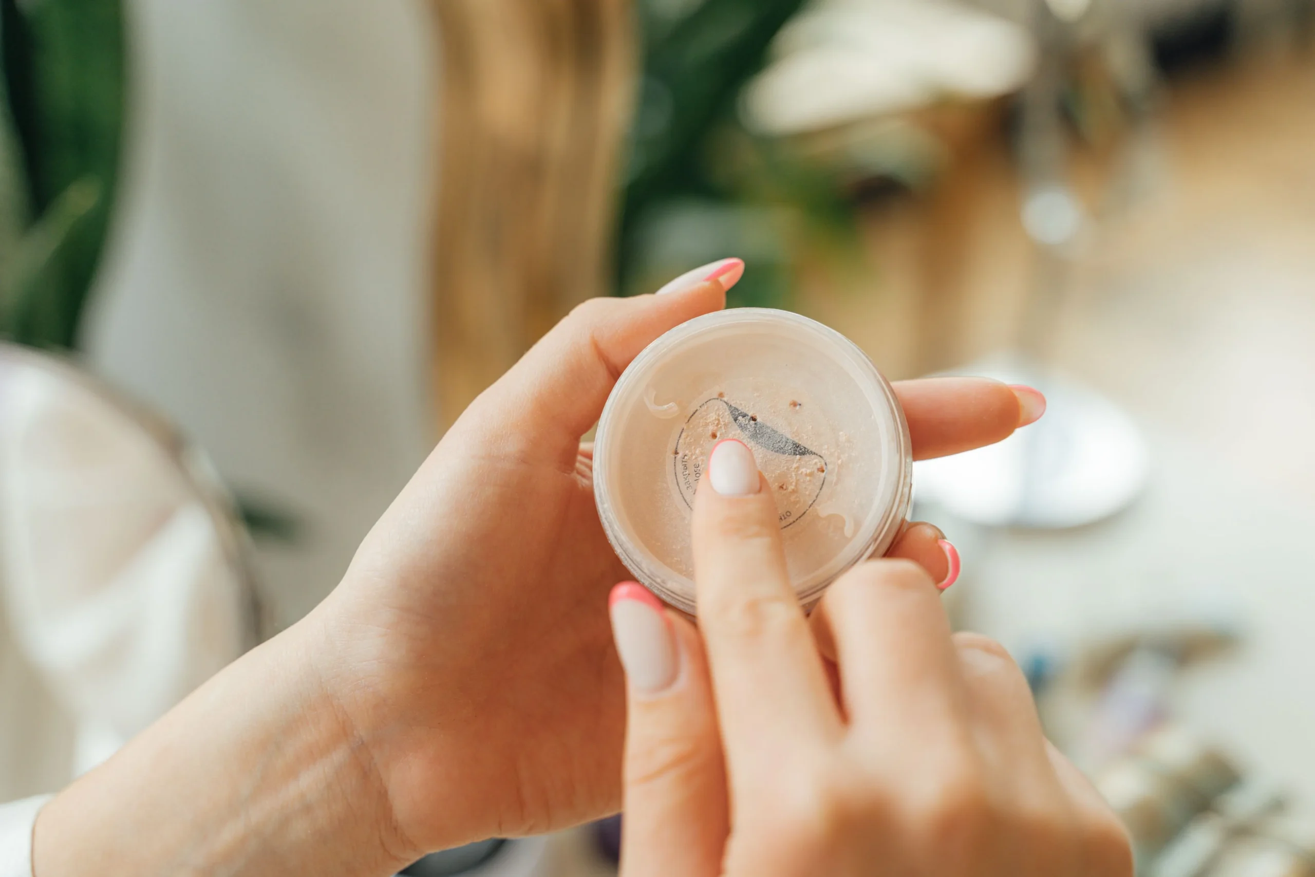 a consumer applies a powdered cosmetic that has been challenge tested to ensure preservative efficacy