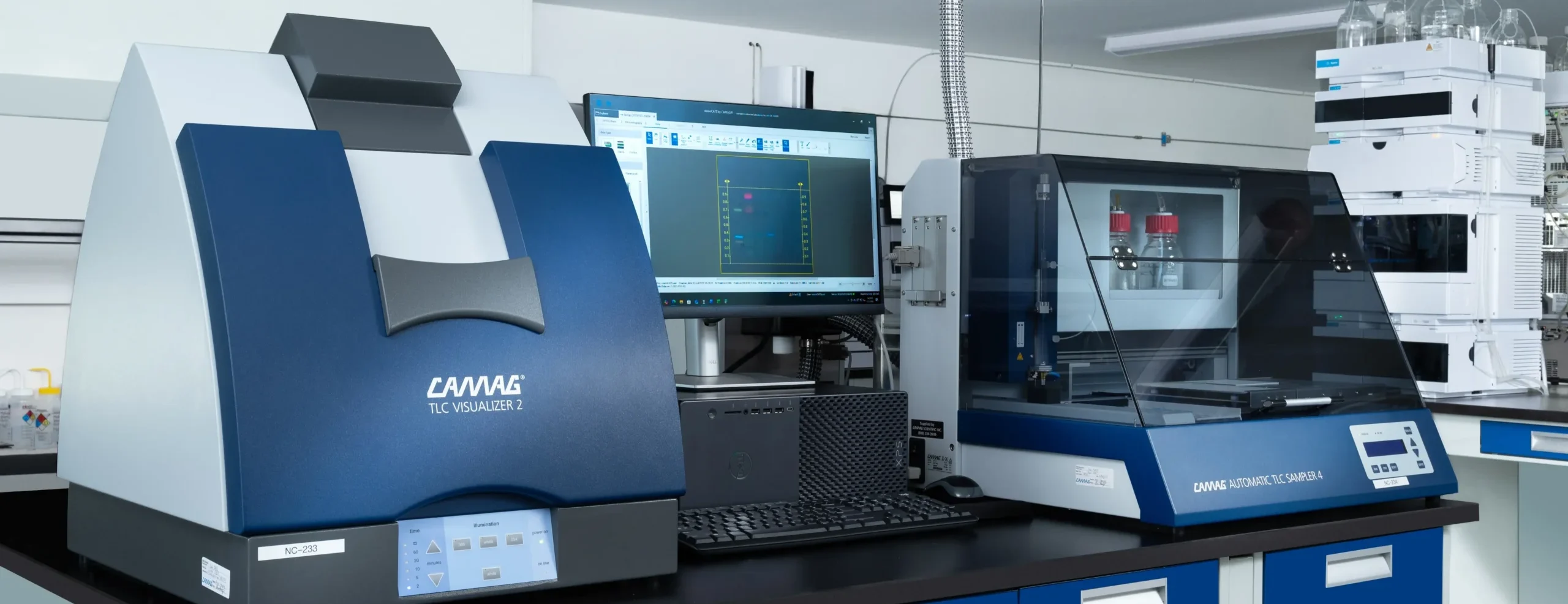 Advanced laboratory with HPTLC visualization equipment, automated sample analyzer, computer monitor, and analytical testing instruments in a third party testing lab. 
