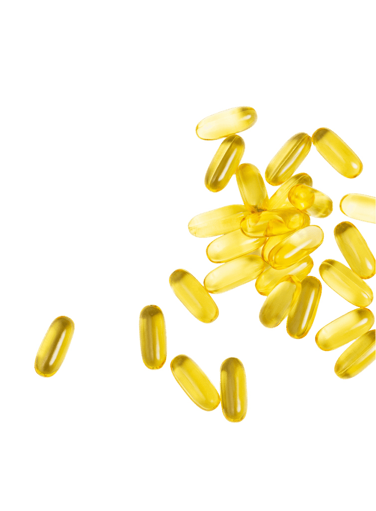 Golden supplement capsules arranged on a white background while they wait on vitamin testing at a supplement testing lab